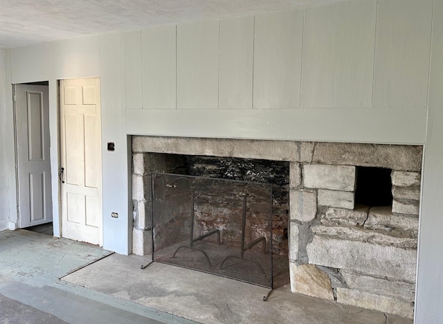 interior details featuring a textured ceiling and a fireplace