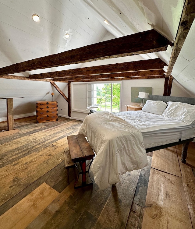 bedroom featuring lofted ceiling with beams and hardwood / wood-style floors