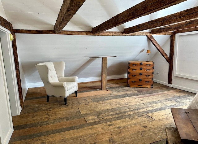 sitting room featuring beam ceiling, dark hardwood / wood-style floors, and wood walls