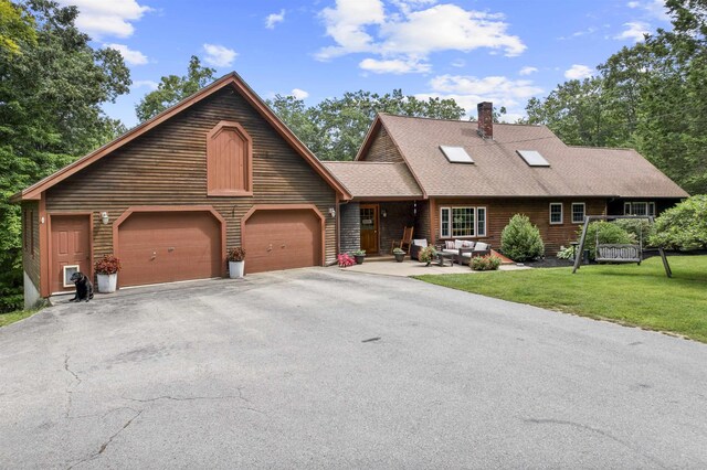 view of front of property with a garage and a front lawn