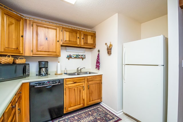 kitchen featuring black appliances, light tile patterned flooring, a textured ceiling, and sink