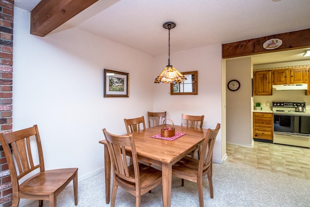 dining space with beam ceiling