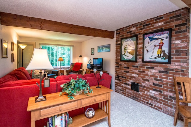 carpeted living room with brick wall and a textured ceiling