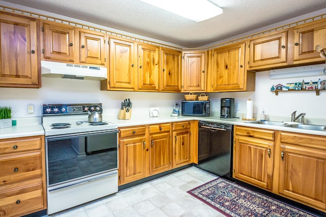 kitchen featuring black appliances, a textured ceiling, and sink