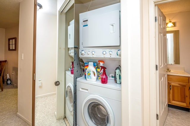 clothes washing area featuring sink, a textured ceiling, and stacked washer / drying machine