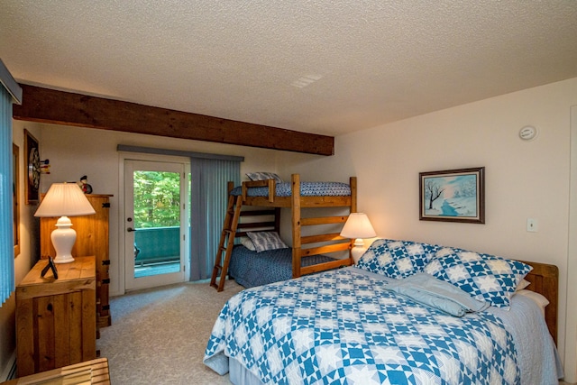 bedroom with a textured ceiling, access to outside, and light carpet