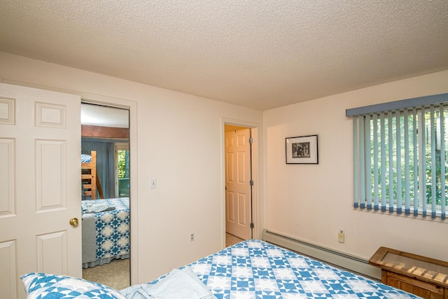 bedroom featuring a baseboard radiator and a textured ceiling