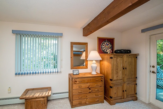 living area with a baseboard radiator, beam ceiling, and a wealth of natural light