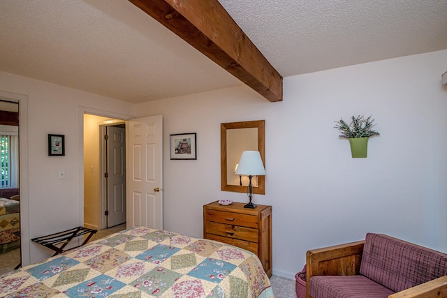 carpeted bedroom featuring a textured ceiling and beamed ceiling