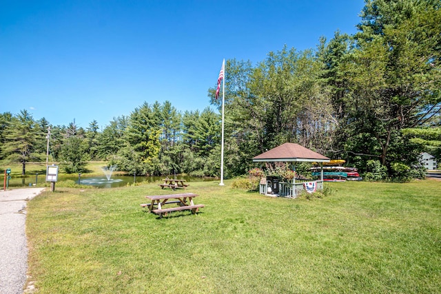 view of yard with a gazebo and a water view