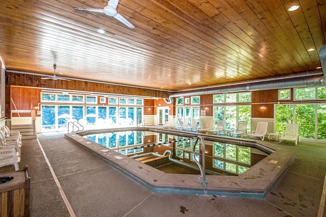 view of swimming pool with ceiling fan and a hot tub