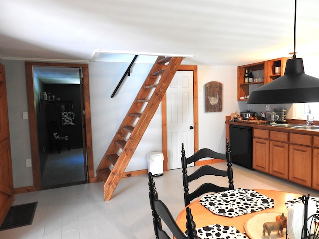 dining room with crown molding and sink