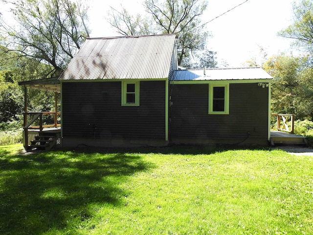 rear view of property with a yard and a deck