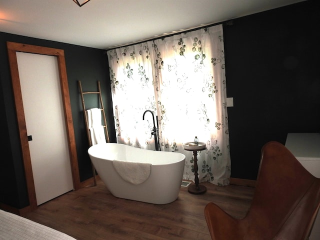 bathroom featuring a tub and hardwood / wood-style floors