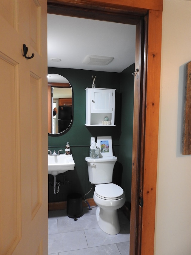 bathroom with tile patterned flooring, toilet, and sink