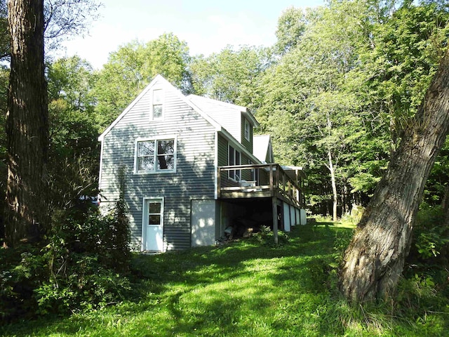 view of side of property with a yard and a deck