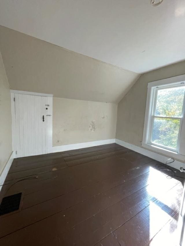 bonus room featuring lofted ceiling and dark hardwood / wood-style floors