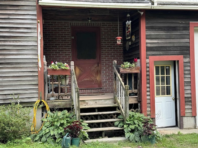 view of exterior entry featuring brick siding