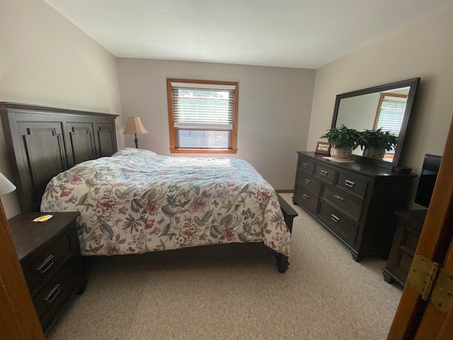 bedroom featuring light colored carpet