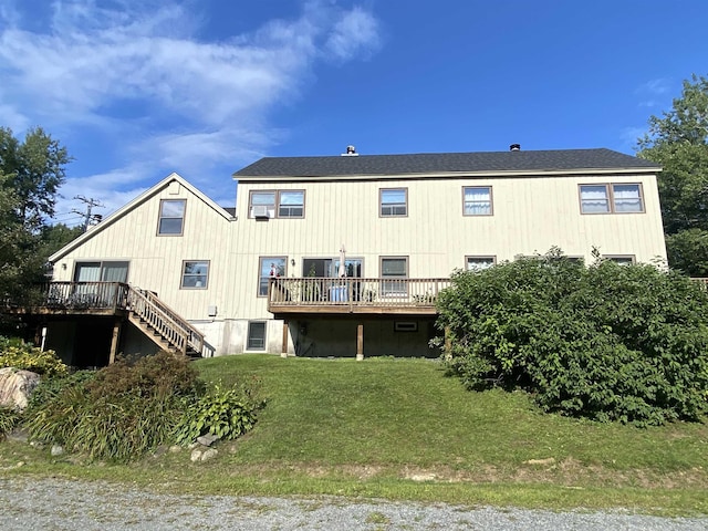 back of house with a shingled roof, a yard, stairway, and a wooden deck