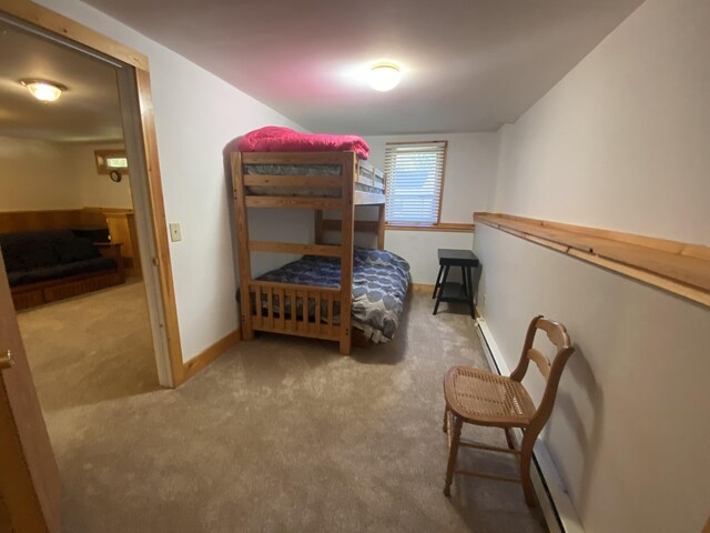 bedroom featuring baseboard heating and dark colored carpet