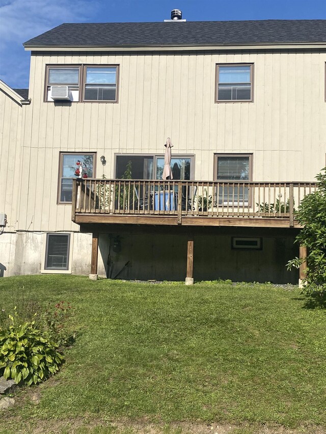 rear view of house with a lawn and a deck