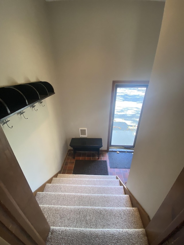 staircase with visible vents and tile patterned floors