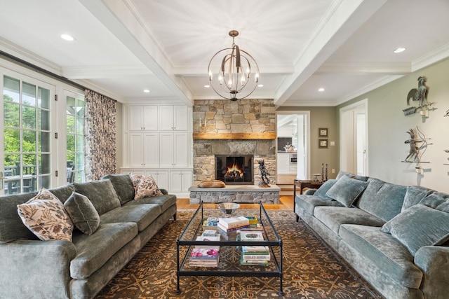 living room with beam ceiling, dark hardwood / wood-style flooring, a chandelier, a fireplace, and ornamental molding