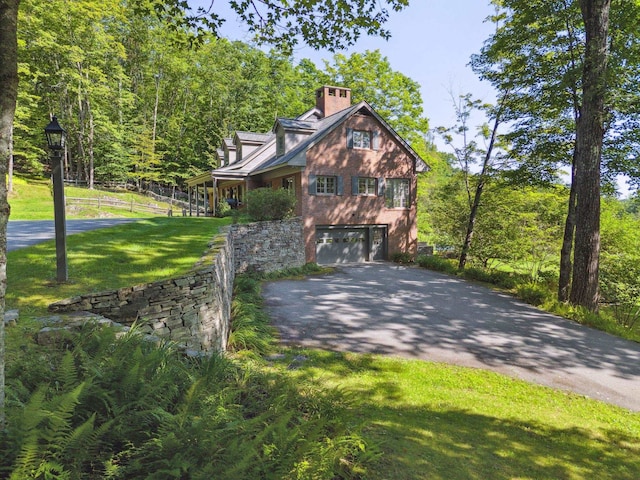 view of front of house featuring a garage and a front yard