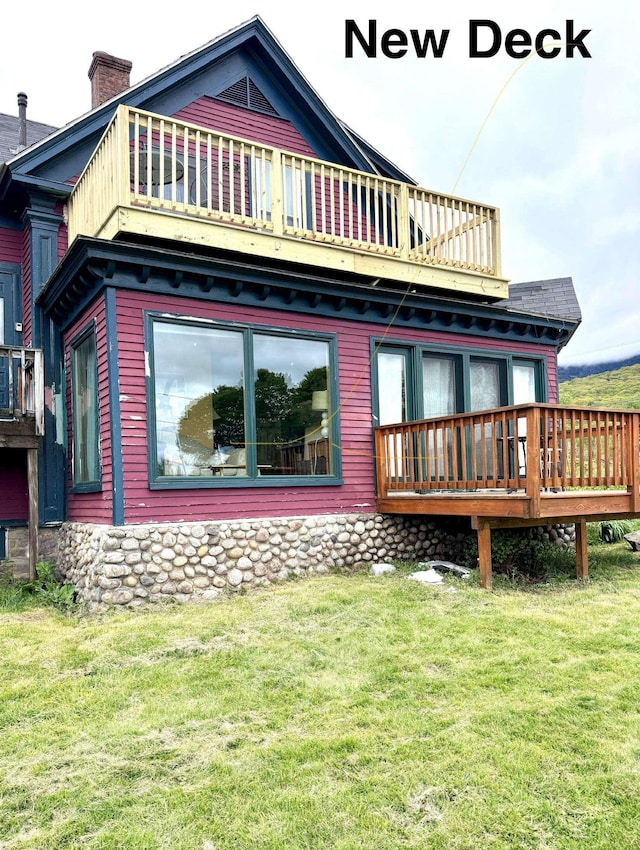 110 Meadows Rd, Jefferson, NH 03583 - back of property with a yard, a chimney, a deck, and a balcony