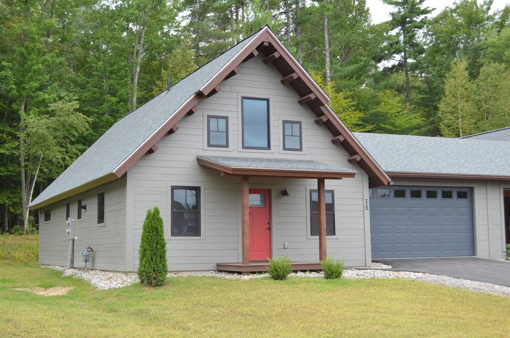 view of front facade with a front yard and a garage