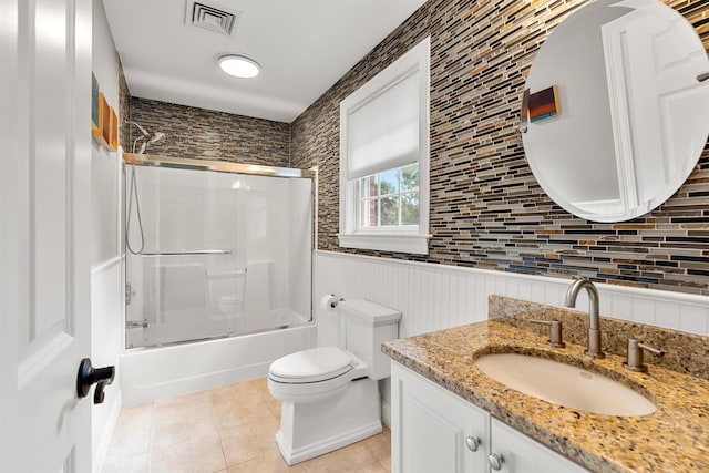 full bath featuring visible vents, toilet, tile patterned flooring, enclosed tub / shower combo, and vanity