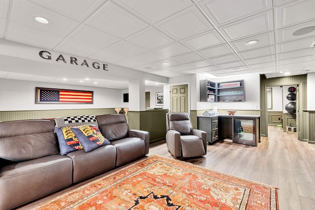 living room featuring recessed lighting, light wood-type flooring, and wainscoting