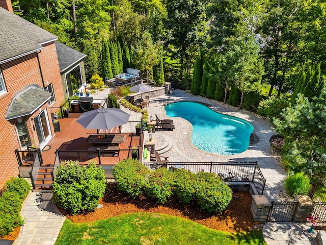 view of pool featuring a fenced in pool, a patio, a deck, and stairway