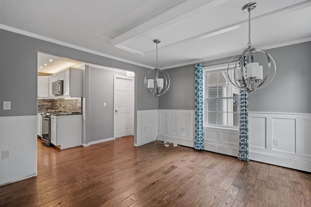 unfurnished dining area featuring crown molding and hardwood / wood-style floors