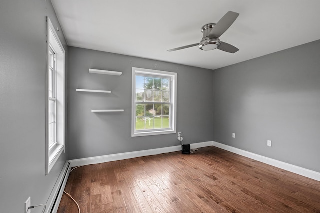 unfurnished room with a baseboard heating unit, ceiling fan, and dark hardwood / wood-style floors