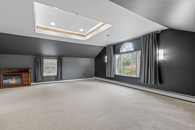 additional living space featuring vaulted ceiling, baseboard heating, and carpet floors