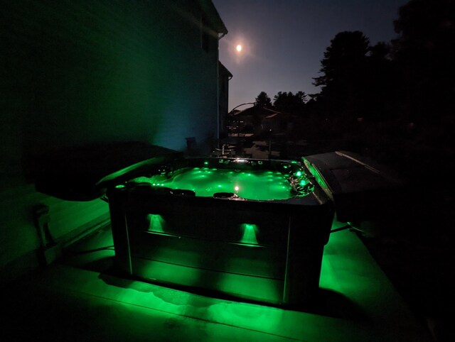 view of patio with a hot tub and a storage unit