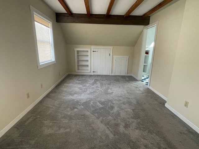 interior space with carpet and lofted ceiling with beams