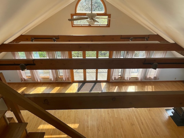 staircase featuring lofted ceiling, hardwood / wood-style floors, and ceiling fan