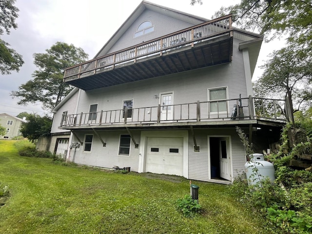 back of property with a lawn and an attached garage