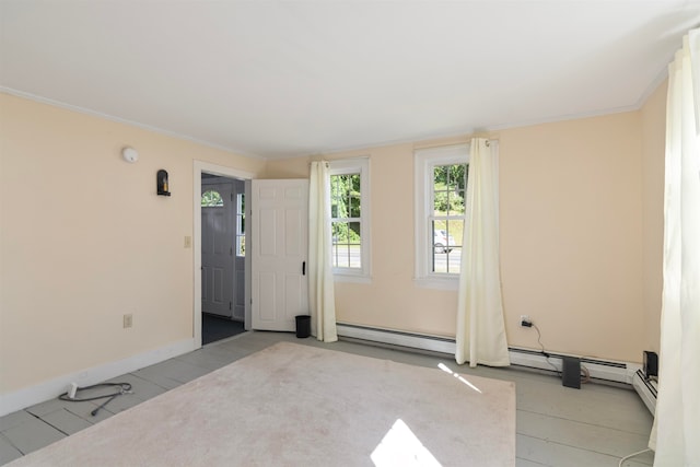 carpeted spare room featuring a baseboard radiator and ornamental molding