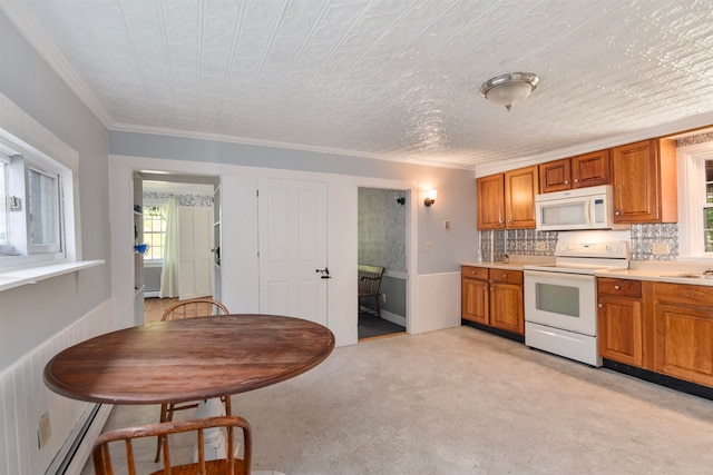 kitchen with crown molding, light carpet, white appliances, and decorative backsplash