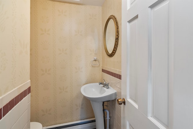 bathroom with tile walls and toilet