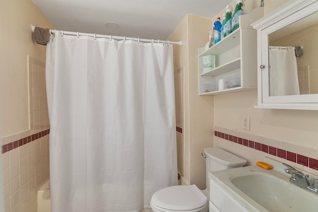 bathroom featuring curtained shower, tile walls, toilet, and vanity