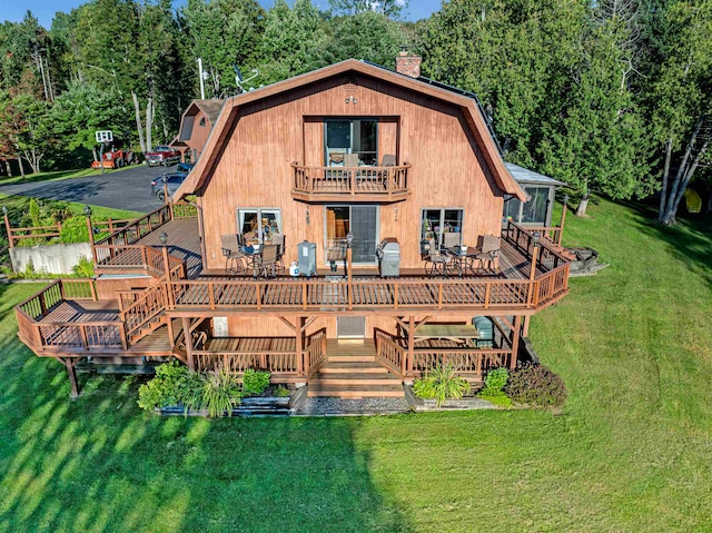 back of property featuring a yard and a deck