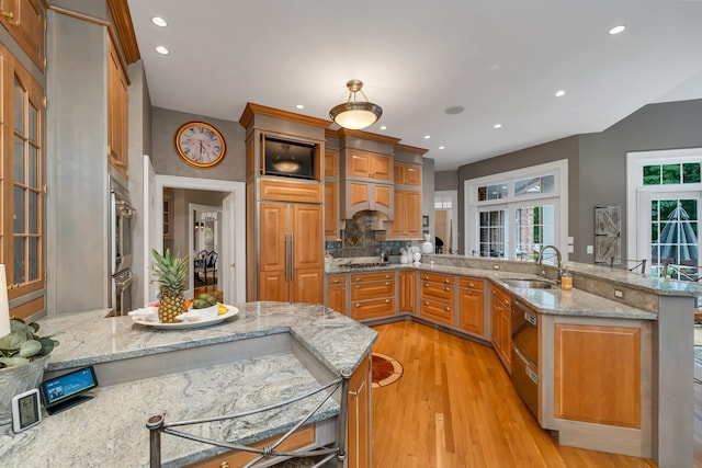 kitchen featuring light hardwood / wood-style flooring, french doors, kitchen peninsula, sink, and light stone counters