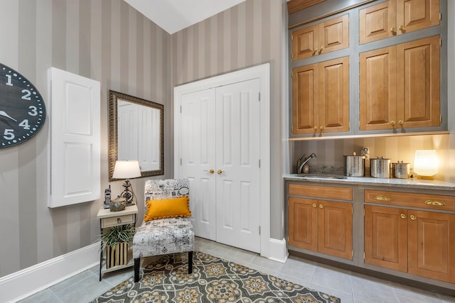 living area featuring light tile patterned floors and sink