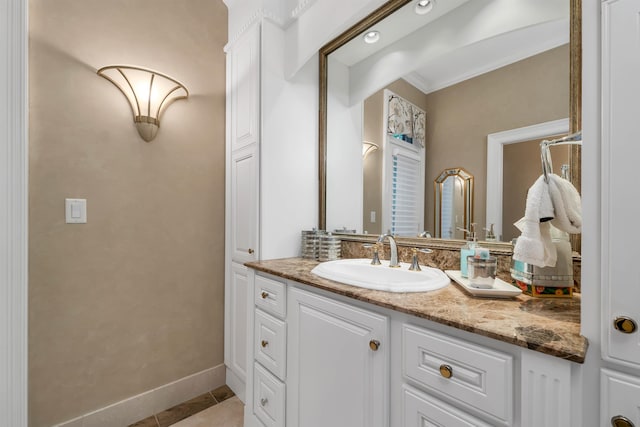 bathroom featuring ornamental molding, vanity, and tile patterned flooring