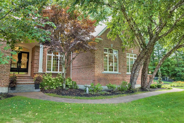 view of side of home featuring a lawn